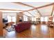 Large living room with a brick fireplace, exposed beams, and hardwood floors at 222 Providence Rd, Fayetteville, GA 30215