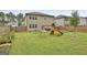 Backyard features a swing set with a slide and climbing area, perfect for Gathering enjoyment at 734 Lanarck Way, Peachtree City, GA 30269