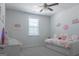 Bright bedroom with window and decorative cartoon themed artwork on walls at 734 Lanarck Way, Peachtree City, GA 30269