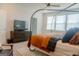 Bright bedroom featuring a comfortable bed, wooden dresser with TV and plenty of natural light at 734 Lanarck Way, Peachtree City, GA 30269