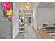 Bright entryway featuring a decorative chandelier, stylish console table, and a neutral-toned rug at 734 Lanarck Way, Peachtree City, GA 30269