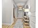 Open entryway with hardwood floors, a decorative light fixture, and modern decor at 734 Lanarck Way, Peachtree City, GA 30269