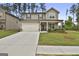 Lovely two-story home with a two-car garage, covered porch, and a beautifully maintained front yard at 734 Lanarck Way, Peachtree City, GA 30269