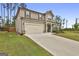 Inviting front exterior of a home with a two-car garage and a covered porch with rocking chairs at 734 Lanarck Way, Peachtree City, GA 30269