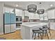 Modern kitchen with a large island, stainless steel appliances, and stylish pendant lighting at 734 Lanarck Way, Peachtree City, GA 30269