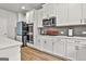 Well-equipped kitchen with sleek appliances, subway tile backsplash, and ample counter space at 734 Lanarck Way, Peachtree City, GA 30269