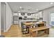 Modern kitchen with white cabinets, stainless steel appliances, and a wooden dining table at 734 Lanarck Way, Peachtree City, GA 30269