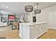 Open-concept kitchen with a central island and view into the living area at 734 Lanarck Way, Peachtree City, GA 30269