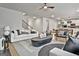 Open-concept living area with modern decor, including a staircase, dining area, and kitchen, perfect for entertaining at 734 Lanarck Way, Peachtree City, GA 30269
