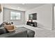 Comfortable living room with gray sofa, carpeted floors, and TV on a console at 734 Lanarck Way, Peachtree City, GA 30269