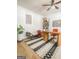 Stylized office boasts a unique desk, vibrant chair, shelving, and a decorative rug for a contemporary feel at 734 Lanarck Way, Peachtree City, GA 30269
