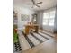 Bright office space featuring a modern desk, geometric rug, and built-in shelving for stylish organization at 734 Lanarck Way, Peachtree City, GA 30269