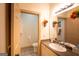 Half bath with granite countertops, undermount sink, and framed mirror with a decorative floral arrangement at 2279 Fieldstone Dr, Conyers, GA 30013