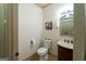Elegant half-bathroom with a decorative mirror, wooden vanity, and stylish fixtures at 2279 Fieldstone Dr, Conyers, GA 30013