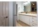 A bathroom features a light countertop, white cabinets, tan tile floor, and a view of a second bathroom at 2279 Fieldstone Dr, Conyers, GA 30013