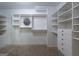 Walk-in closet featuring custom shelving units and drawers at 2279 Fieldstone Dr, Conyers, GA 30013