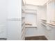 The walk-in closet has painted white walls, carpet flooring, and open storage shelving at 2279 Fieldstone Dr, Conyers, GA 30013