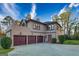 View of home's exterior featuring a three-car garage, private entrance and manicured landscaping at 2279 Fieldstone Dr, Conyers, GA 30013