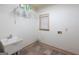 Laundry room with utility sink, shelving, window, tiled floor and hookups at 2279 Fieldstone Dr, Conyers, GA 30013