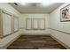 Spacious living room with multiple windows, crown molding, and sleek wood floors at 2279 Fieldstone Dr, Conyers, GA 30013