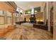 Spacious living room featuring a stone fireplace, large arched windows, custom trim, gleaming floors, and neutral decor at 2279 Fieldstone Dr, Conyers, GA 30013