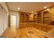 Office with wooden floors, wall-to-wall bookshelf and cabinet with view of entryway at 2279 Fieldstone Dr, Conyers, GA 30013