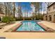Fenced-in in-ground pool with an attached spa and outdoor entertaining space at 2279 Fieldstone Dr, Conyers, GA 30013
