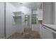 Well-organized walk-in closet with built-in shelving, mirror, and ample storage space at 2279 Fieldstone Dr, Conyers, GA 30013