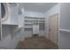 Spacious walk-in closet with custom shelving, drawers, and ample storage for clothing and accessories at 2279 Fieldstone Dr, Conyers, GA 30013
