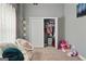 Bright bedroom with modern TV, plush carpeting, and closet with ample storage space for toys at 131 Pecan Lake Dr, Sharpsburg, GA 30277