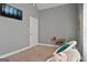 Cozy bedroom featuring neutral walls, plush carpeting, and a comfortable sitting area with modern TV at 131 Pecan Lake Dr, Sharpsburg, GA 30277