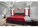 Bright bedroom with vaulted ceiling, red accents, and an ensuite bathroom offering a tranquil retreat at 131 Pecan Lake Dr, Sharpsburg, GA 30277