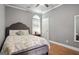 Bright bedroom with a large window, hardwood floors, and a comfortable bed offering a relaxing space at 131 Pecan Lake Dr, Sharpsburg, GA 30277