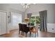 Dining room with a chandelier, gray walls, wainscoting, and a sliding door at 131 Pecan Lake Dr, Sharpsburg, GA 30277