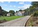 Spacious home with a long driveway and expansive front yard, surrounded by mature trees at 131 Pecan Lake Dr, Sharpsburg, GA 30277