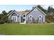 Charming home exterior with well-manicured lawn, lush landscaping, and inviting front entrance at 131 Pecan Lake Dr, Sharpsburg, GA 30277