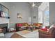 Comfortable living room featuring a fireplace, two couches, and neutral walls at 131 Pecan Lake Dr, Sharpsburg, GA 30277
