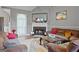 Inviting living room with fireplace, couches, high ceilings, and neutral decor at 131 Pecan Lake Dr, Sharpsburg, GA 30277