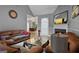 Bright living room with a fireplace, comfortable seating, and a view into the dining area at 131 Pecan Lake Dr, Sharpsburg, GA 30277