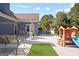 Outdoor patio with dining table, swing, grassy area, and play set in the backyard of the home at 131 Pecan Lake Dr, Sharpsburg, GA 30277