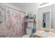 Bathroom featuring an Eiffel Tower shower curtain and a shelving unit over the toilet at 1191 Berryhill Dr, Lithonia, GA 30058