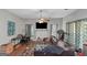 Open-concept living room with hardwood flooring, a ceiling fan, and a wall-mounted television at 1191 Berryhill Dr, Lithonia, GA 30058