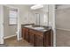 Large bathroom with double sinks, granite counters, and wood cabinetry at 1064 Lear Dr, Locust Grove, GA 30248