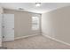 Neutral bedroom featuring carpet, one window with blind, and a white door at 1064 Lear Dr, Locust Grove, GA 30248
