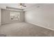 A spacious bedroom with neutral carpet, a ceiling fan, and natural light at 1064 Lear Dr, Locust Grove, GA 30248