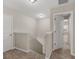 Upstairs hallway with carpet, neutral walls, and an open doorway to the bedroom at 1064 Lear Dr, Locust Grove, GA 30248