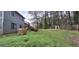 Lush backyard with mature trees, green grass, and a wooden deck, offering a peaceful retreat at 4812 White Oak Path, Stone Mountain, GA 30088