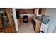 Classic kitchen with wood cabinets, black appliances, tile flooring, and a double basin stainless steel sink at 4812 White Oak Path, Stone Mountain, GA 30088