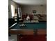 Basement area showcasing a pool table, seating area, and potential for customization, highlighting the property's versatility at 2626 Summit Sw Pkwy, Atlanta, GA 30331
