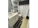 Compact bathroom with a white vanity, decorative shower curtain, and patterned floor mats at 2626 Summit Sw Pkwy, Atlanta, GA 30331